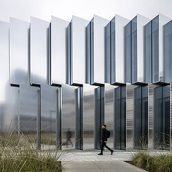 A person walking in front of a building.