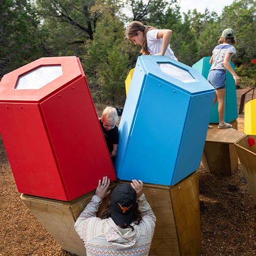 A group of people playing in a play area.