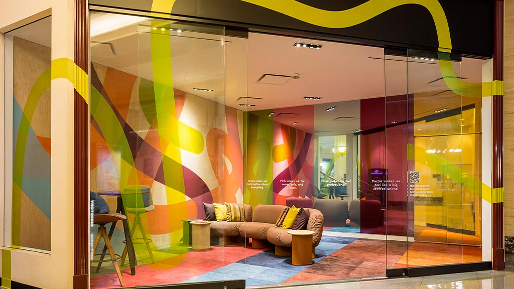 A room with a couch and a glass door.