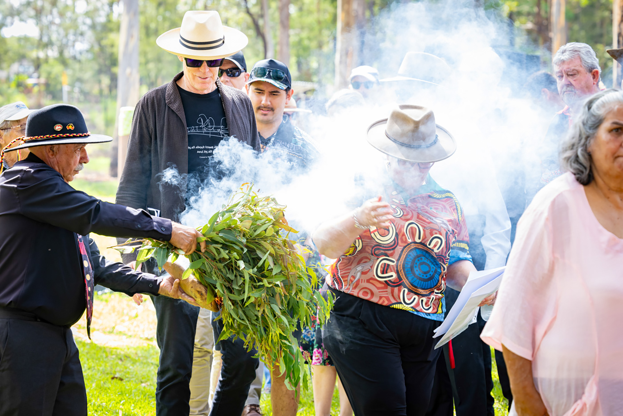 A group of people standing around a fire.