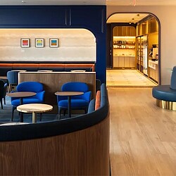 A room with blue chairs and a table.