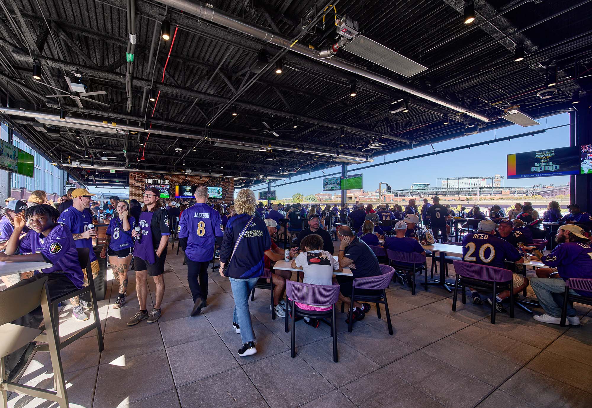 A group of people in a room with tables and chairs.