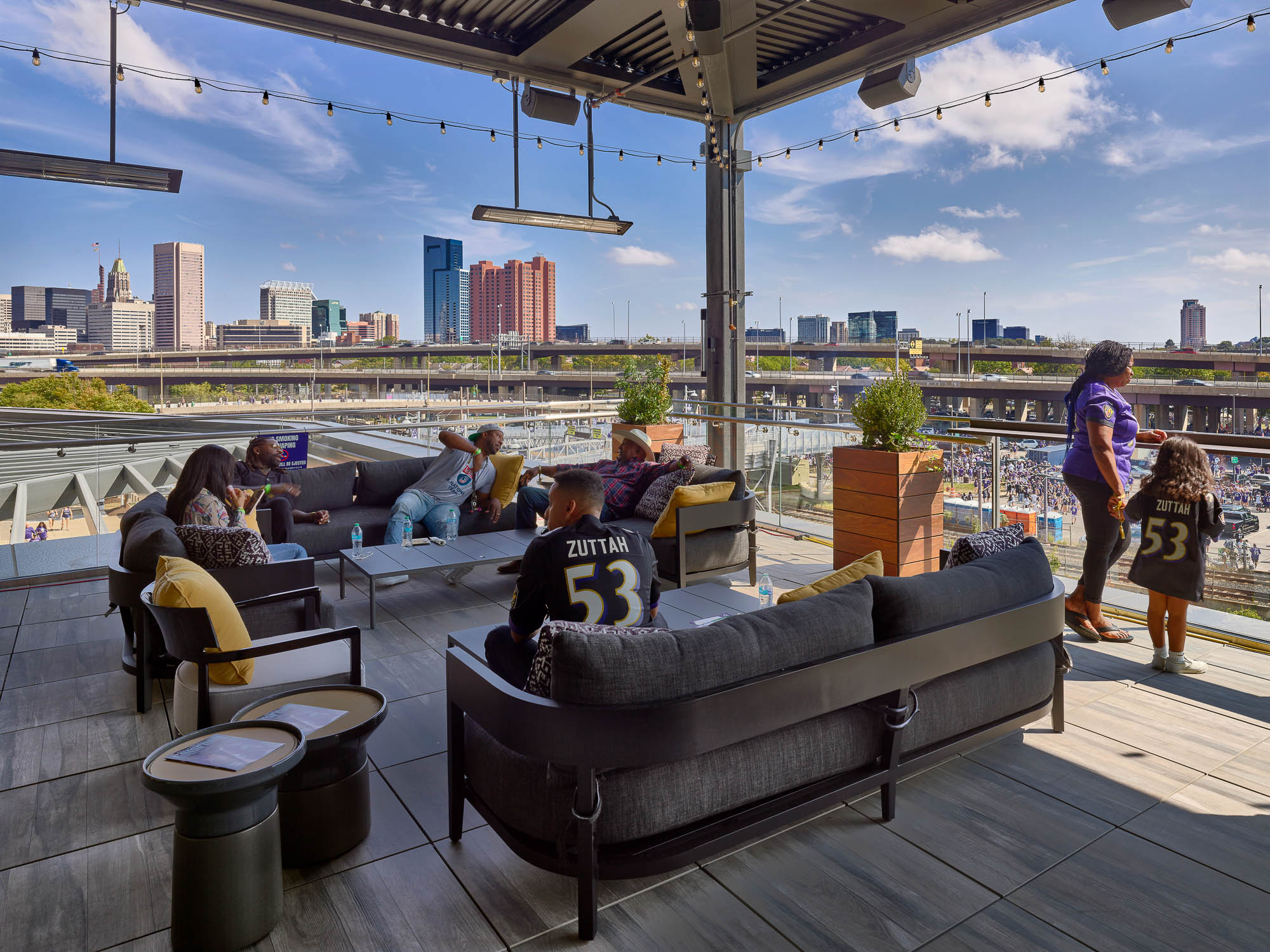 A group of people sitting on a bench in front of a body of water.
