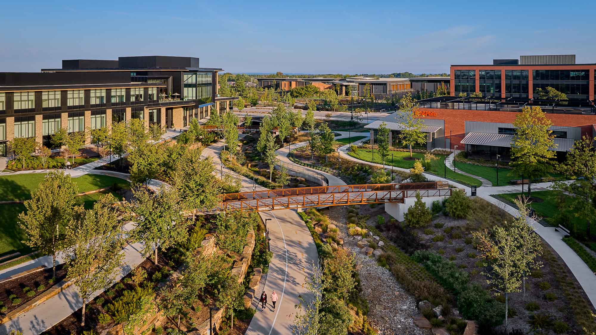 A park with a road and buildings.