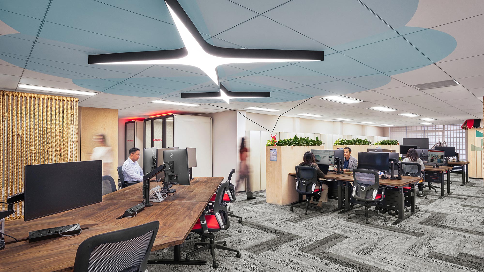 A room with a few people and computers.