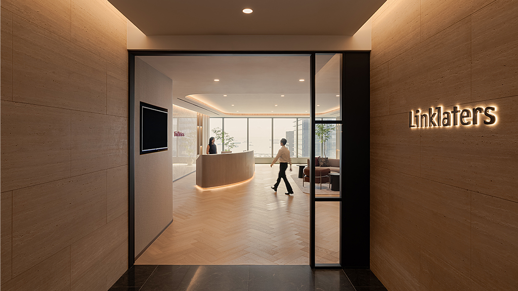 A person walking through a hallway.