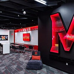 A room with a red screen and chairs.
