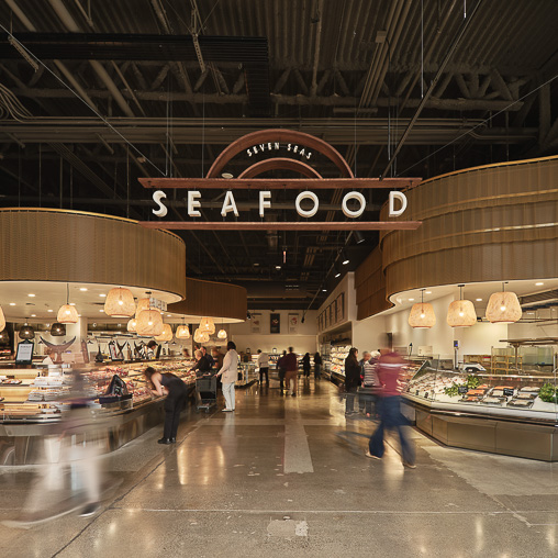 A large room with people and food.