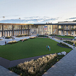 A large building with a green lawn.