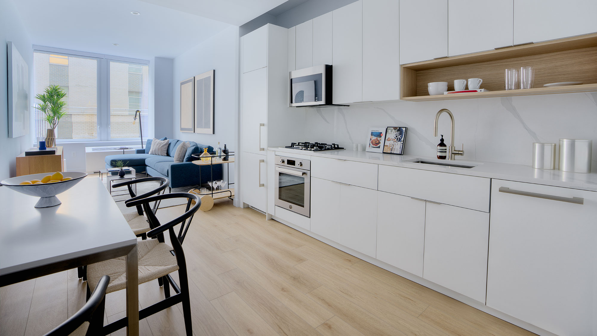 A kitchen with white cabinets.