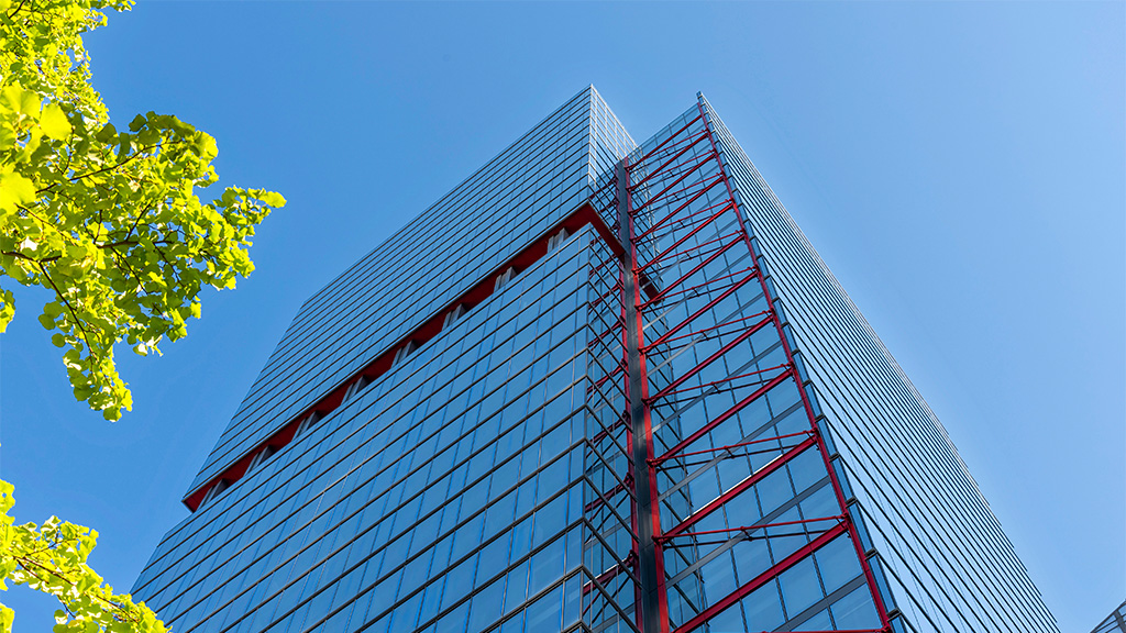 A tall building with a tree in front of it.