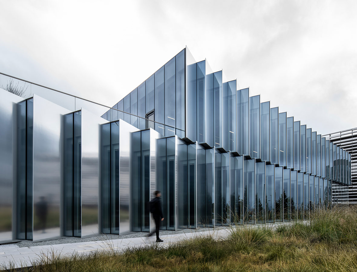 A person walking outside of a building.