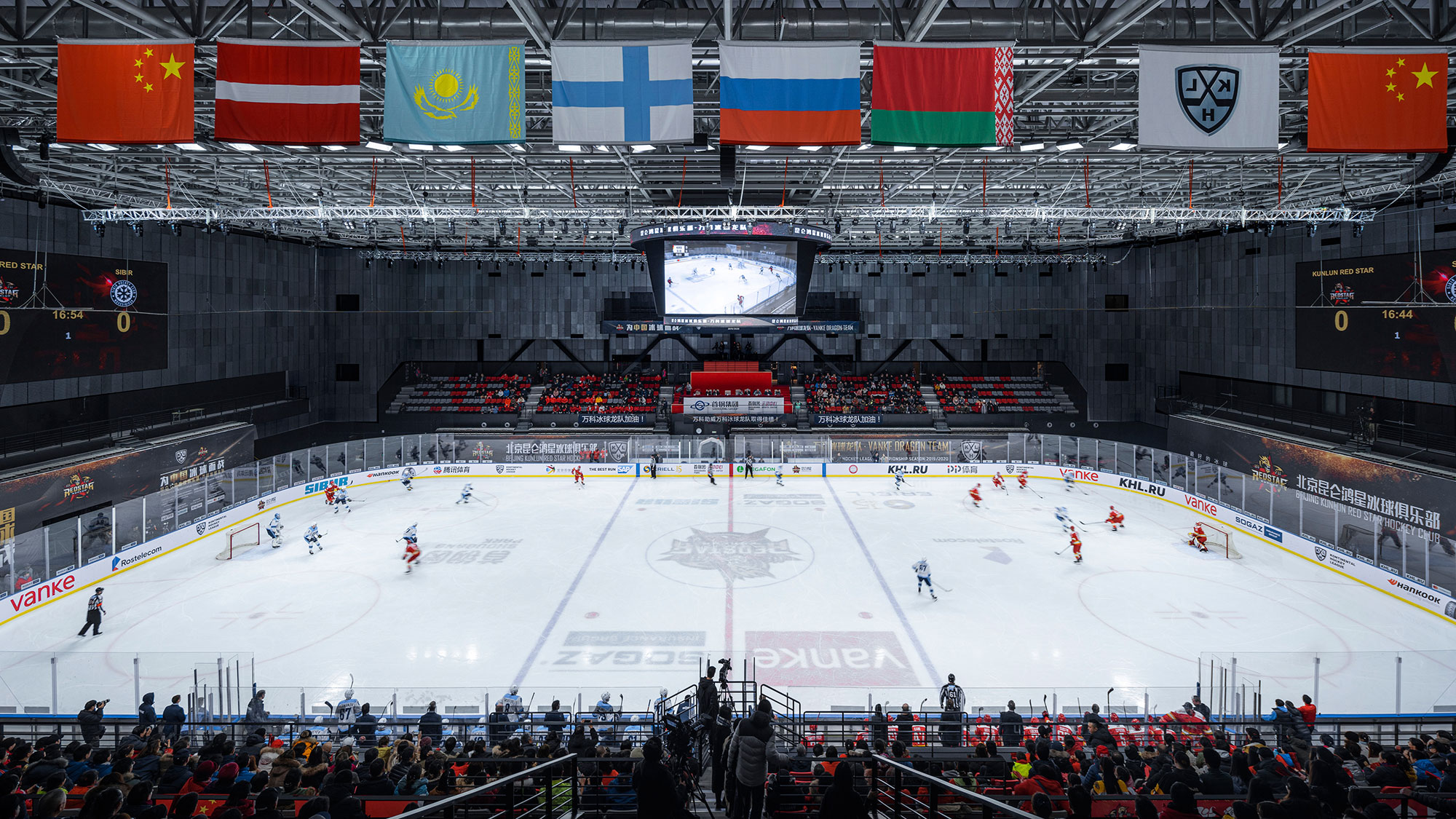 A hockey arena with a crowd watching.