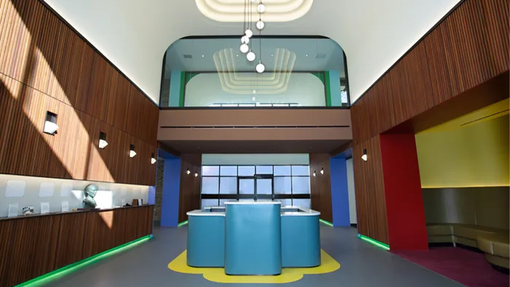 A room with a pool and a large screen.