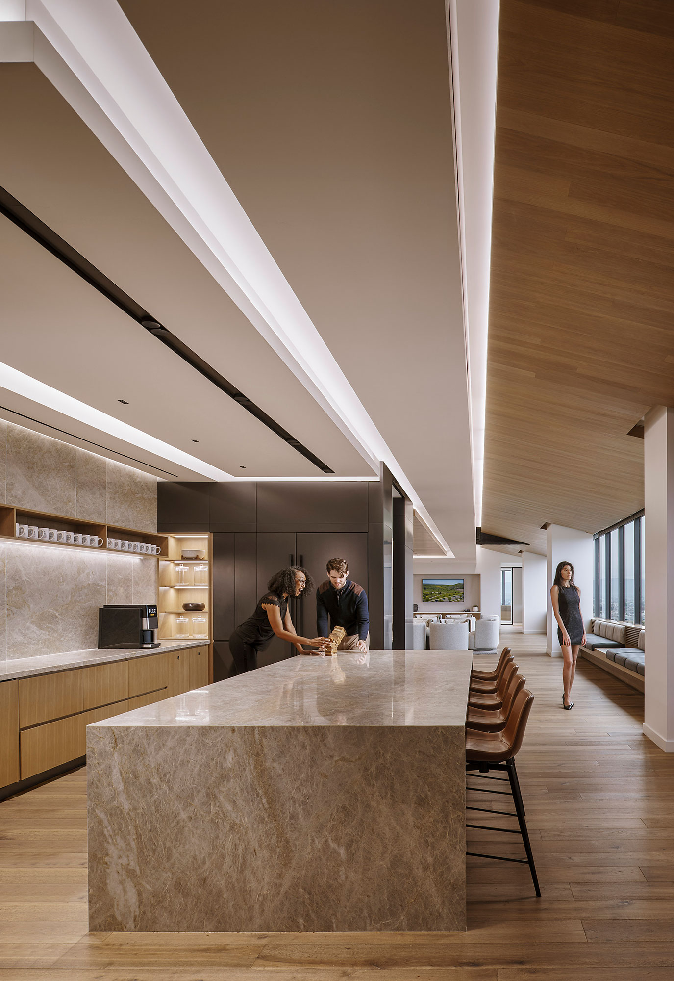 A couple of people stand in a kitchen.