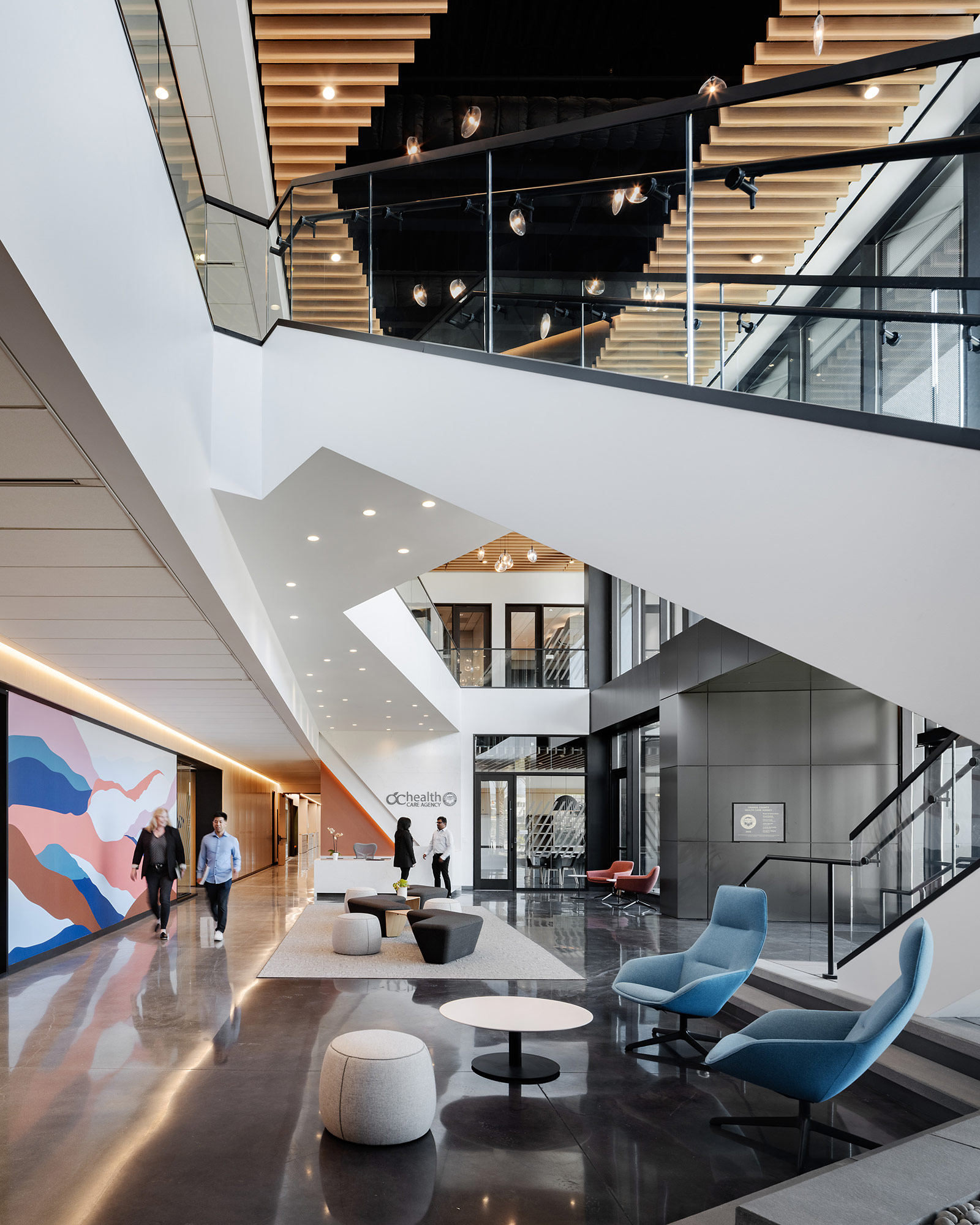 A large white room with a few people and a large white ceiling.