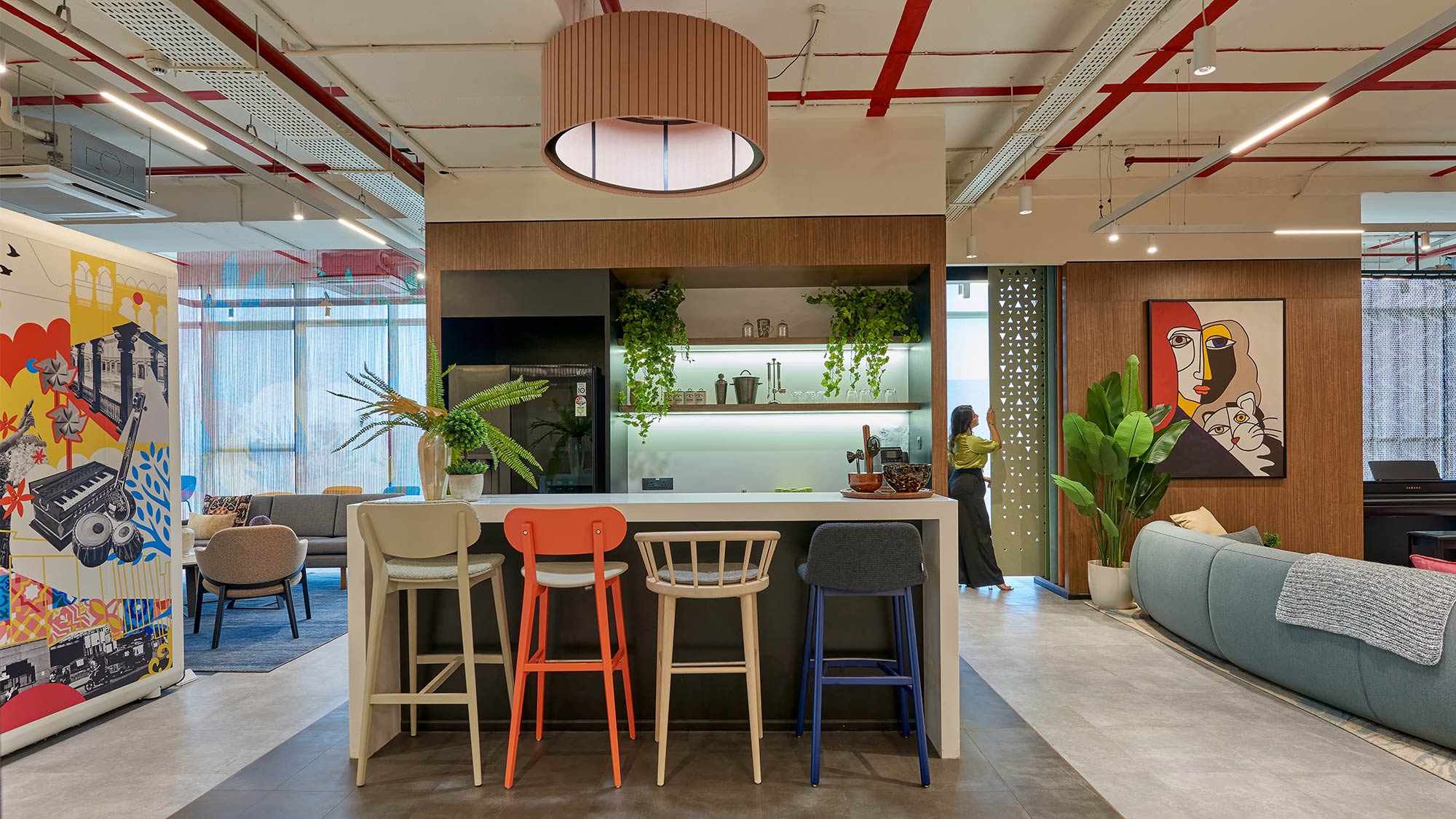 A room with a couch and chairs.