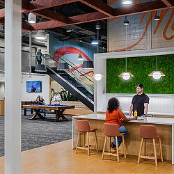 A man and woman sitting at a table in a restaurant.