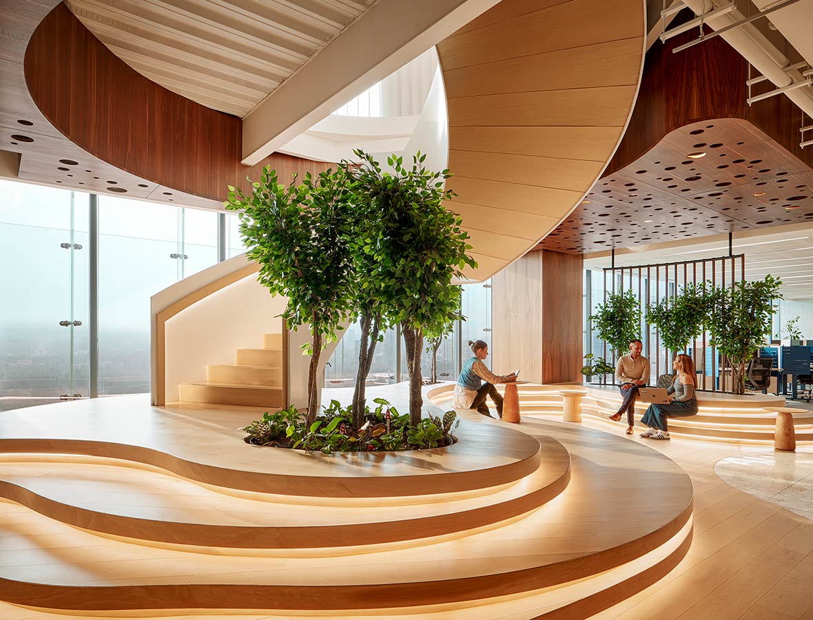 A large indoor courtyard with trees and a building with a large glass ceiling.