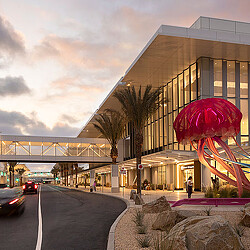 A building with a large sculpture in front of it.