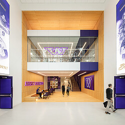 A group of people walking through a building.