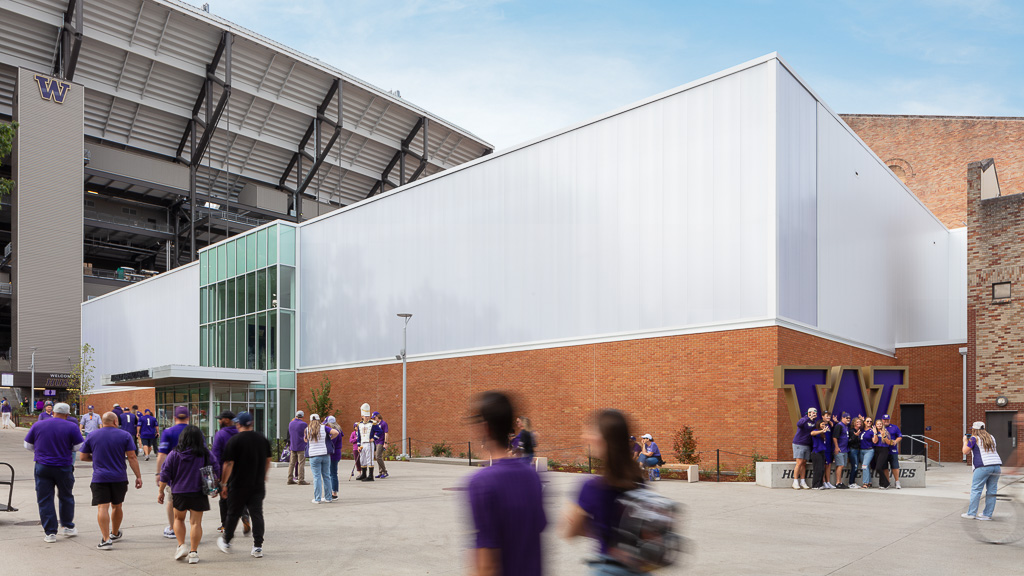 A group of people walking outside a building.