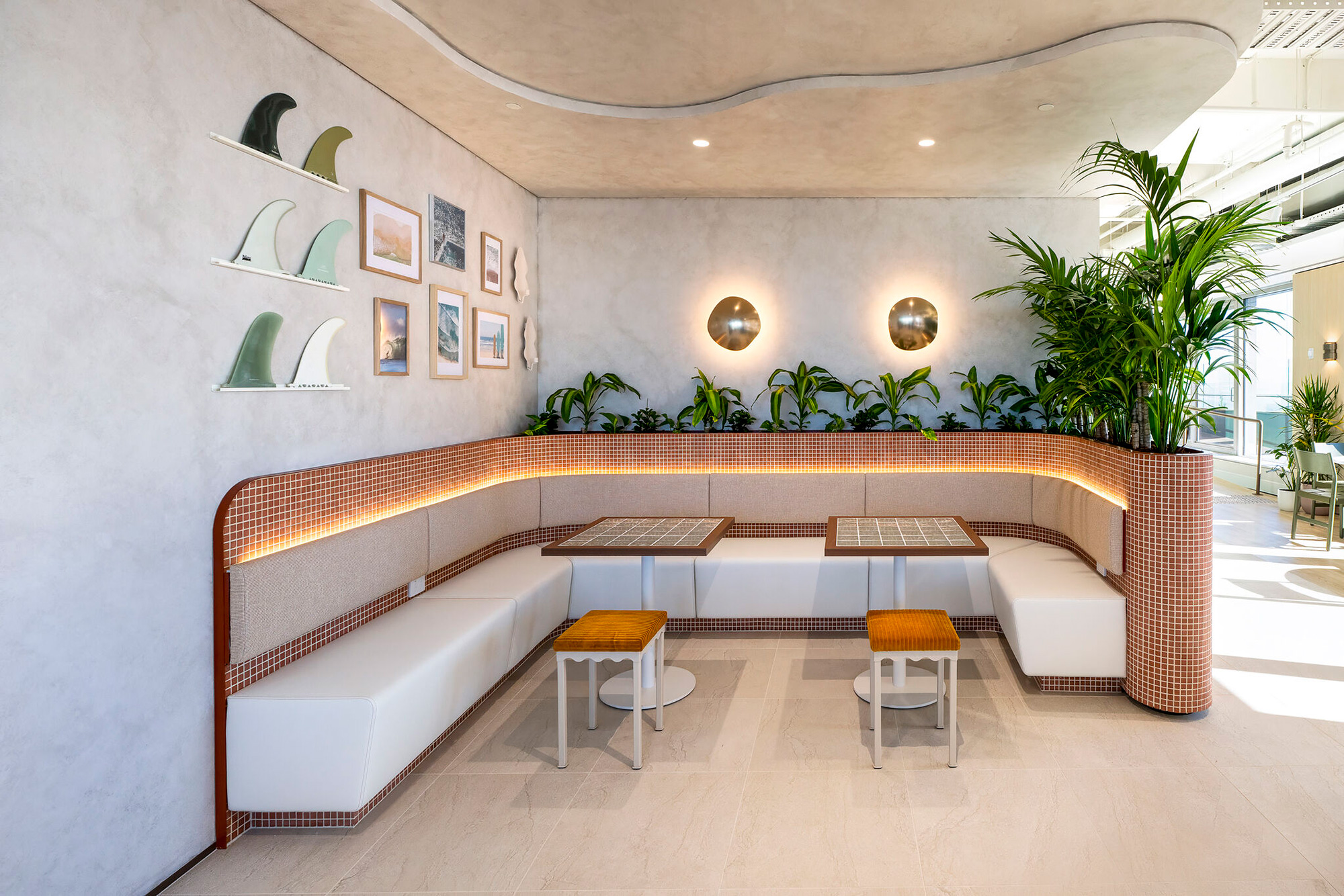 A room with a couch and chairs.