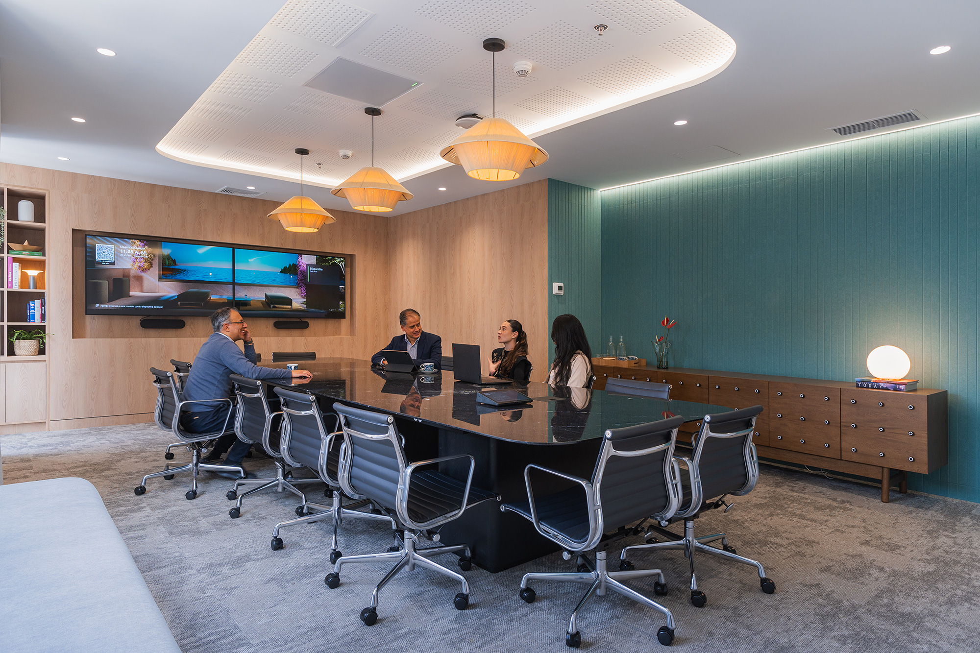 A group of people sitting in chairs in a conference room.