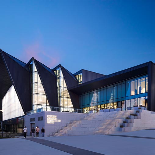 A building with stairs and people walking.