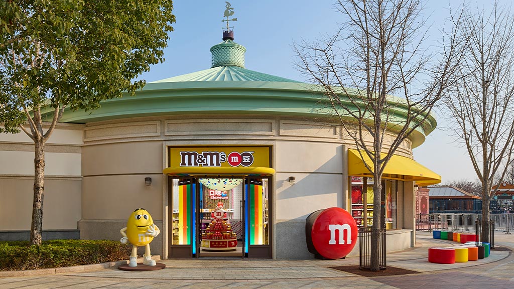 A store front with a yellow duck statue in front.