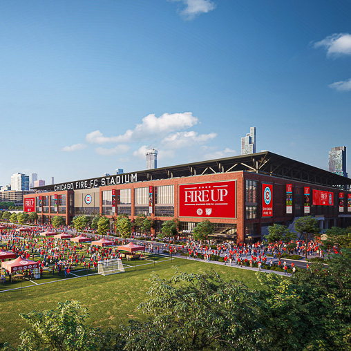 A stadium with a field in front of it.