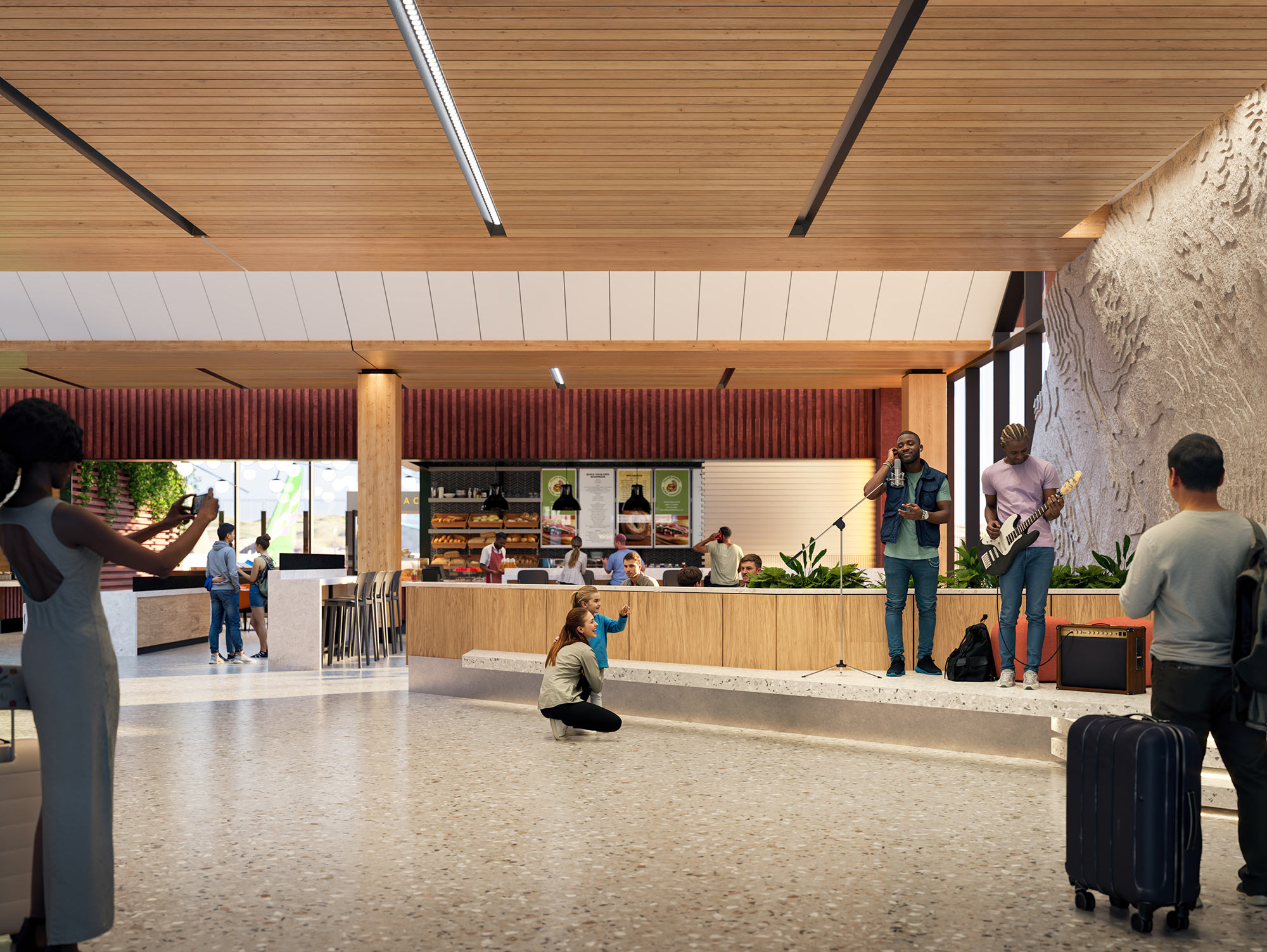 People with luggage in a building.