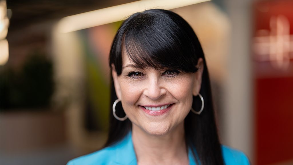 A woman with earrings smiling.