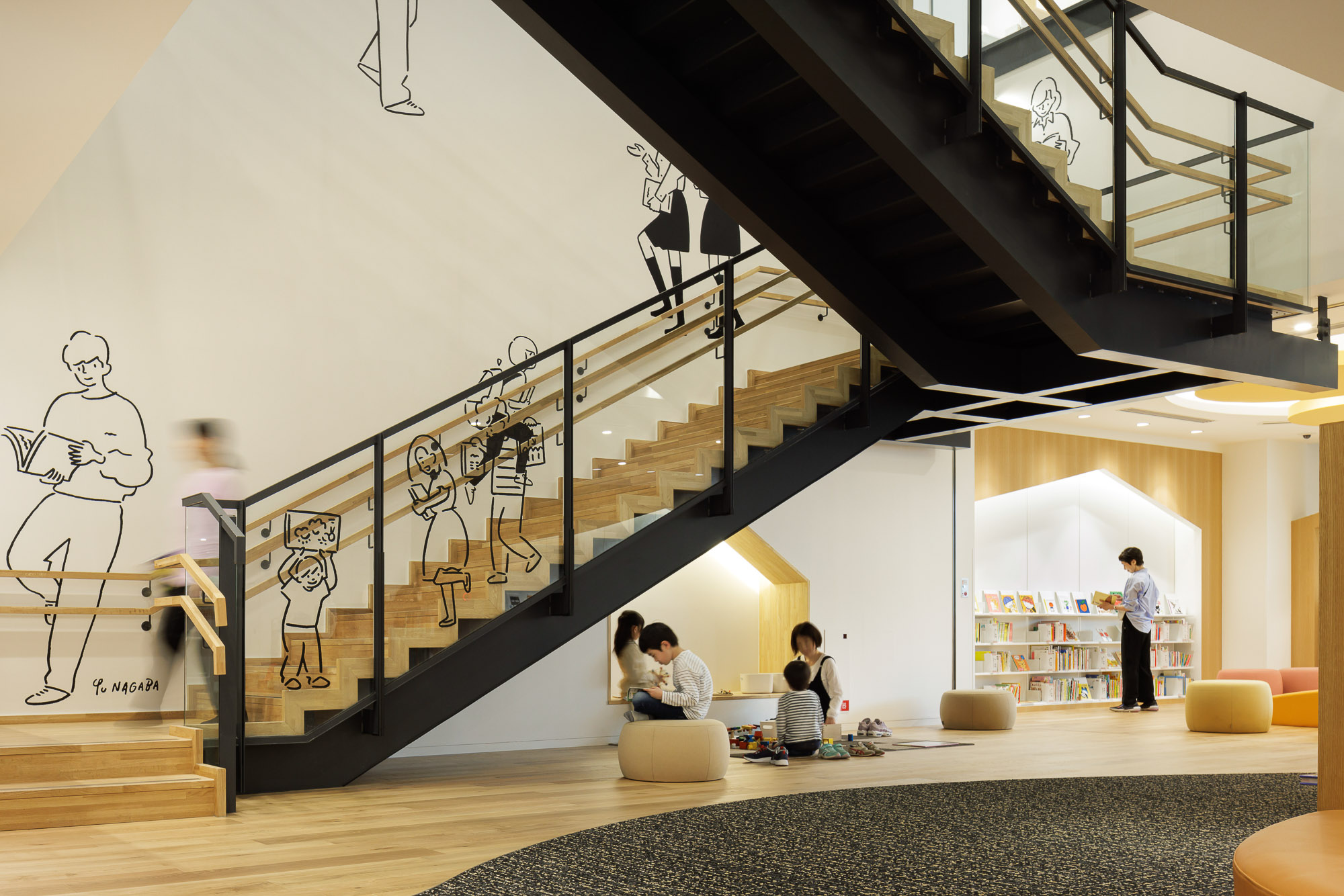 People sitting on the floor of a building.