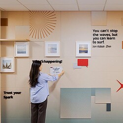 A person writing on a white board.