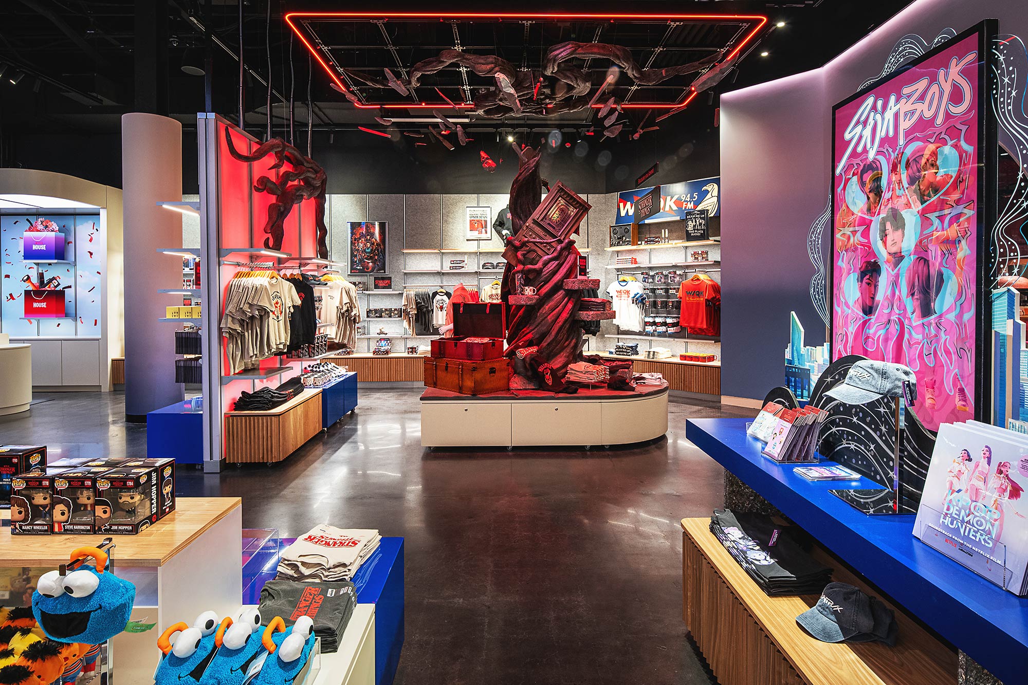 A room with a table and shelves with objects on it.