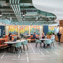 People sitting at tables in a building.