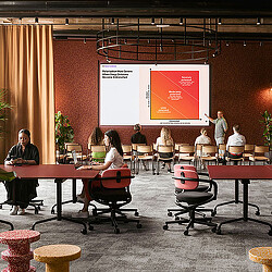 A group of people sitting at tables.