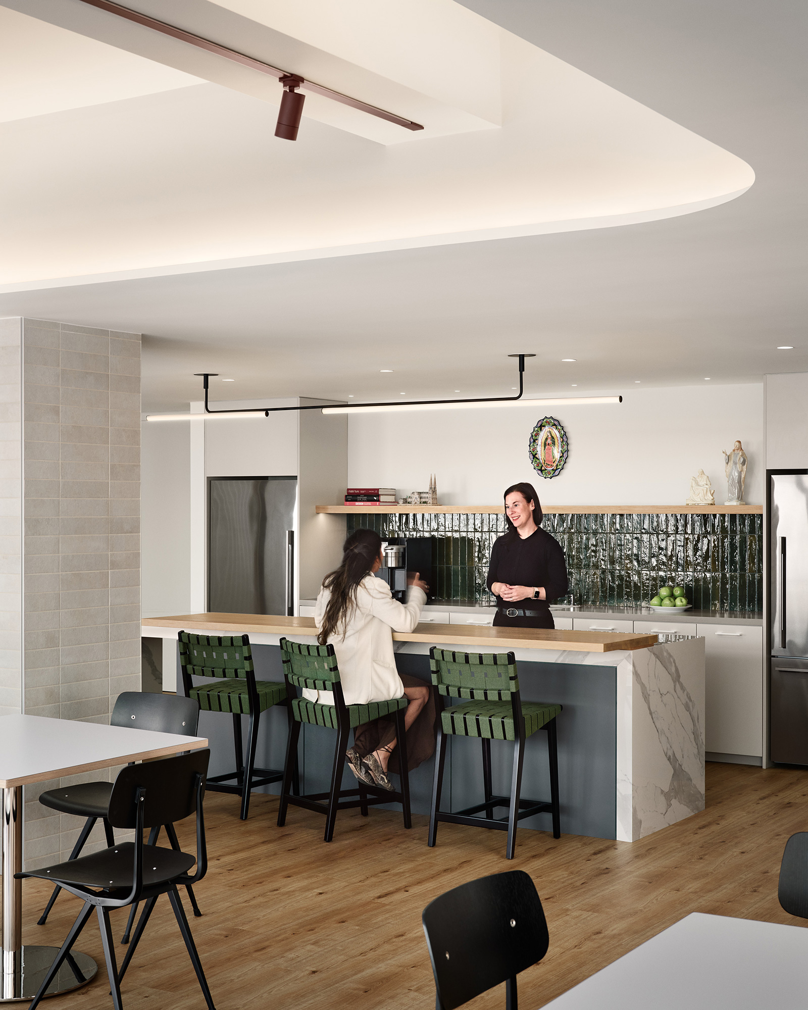 A couple of women sitting at a table in a restaurant.