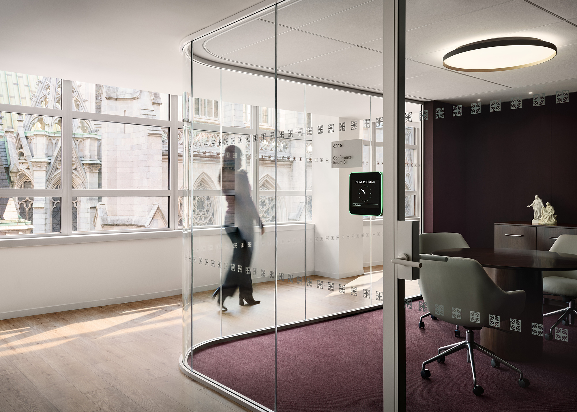 A person walking through a glass door.