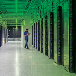 A person standing in a server room.