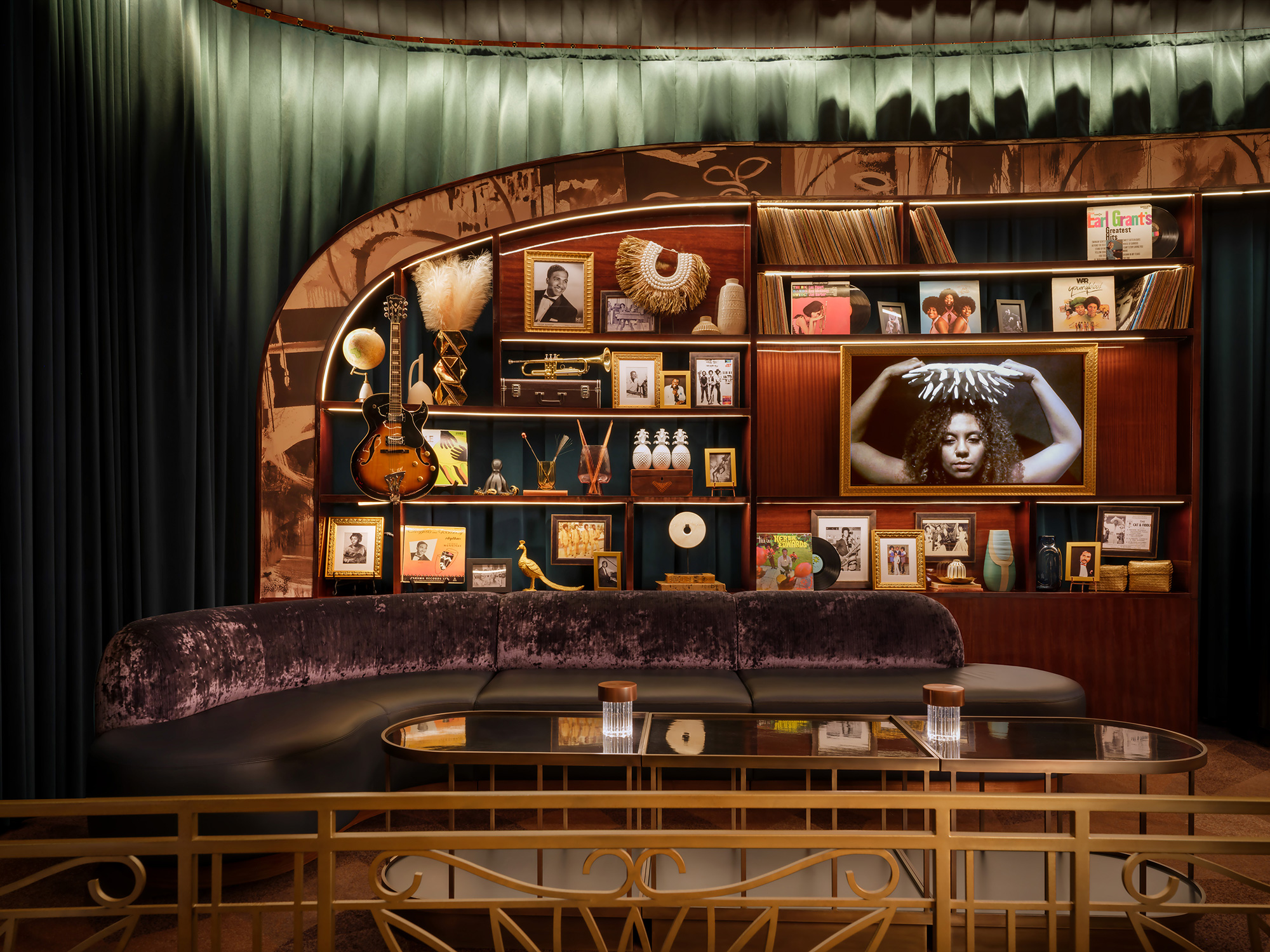 A room with a table and shelves with pictures on it.