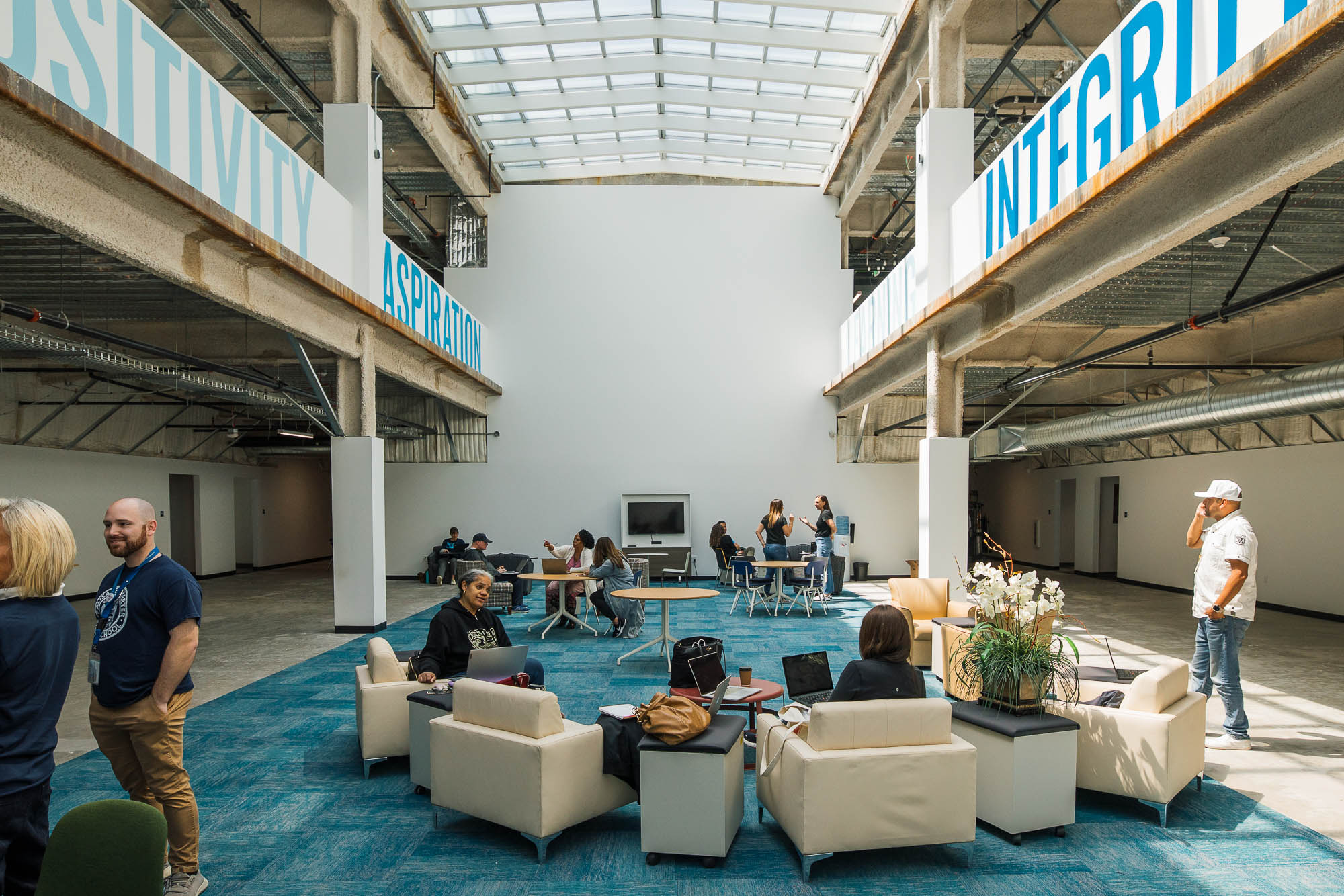 People sitting on couches in a building.