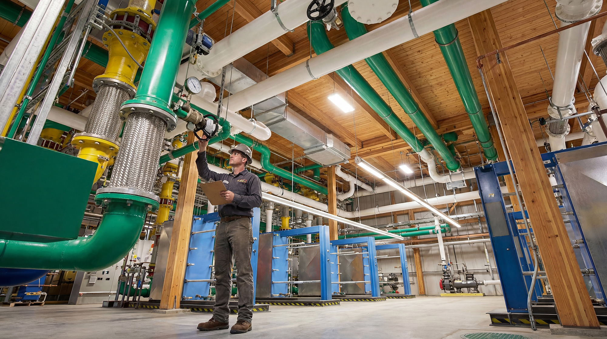 A person standing next to a large green machine.