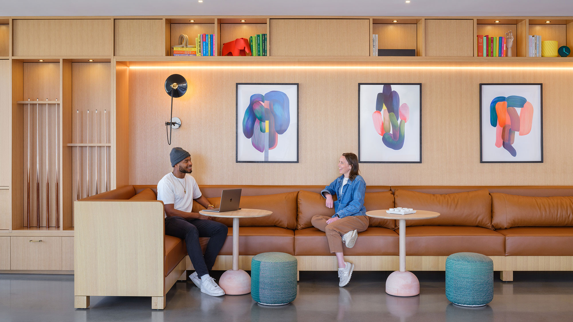 A man and a woman sitting on a couch in a room.