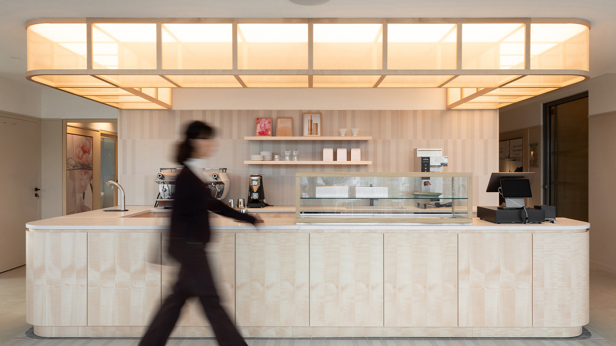 A person walking in a kitchen.