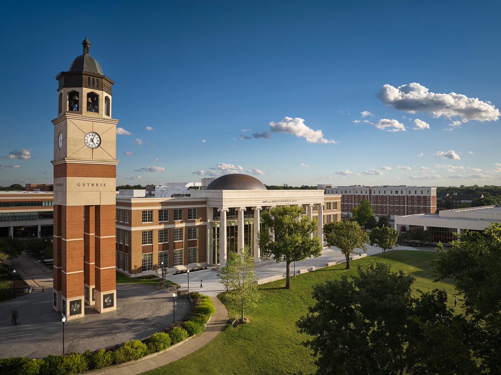 A clock tower in front of a building.