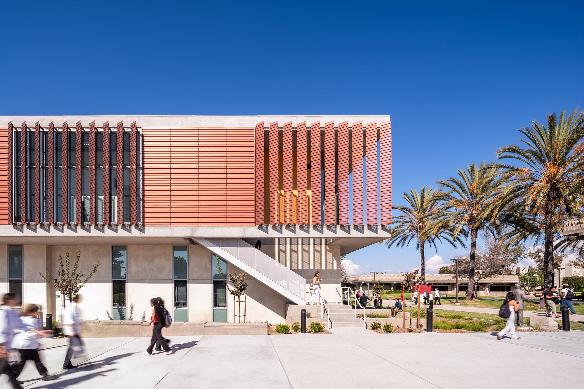 A building with stairs and people walking around.
