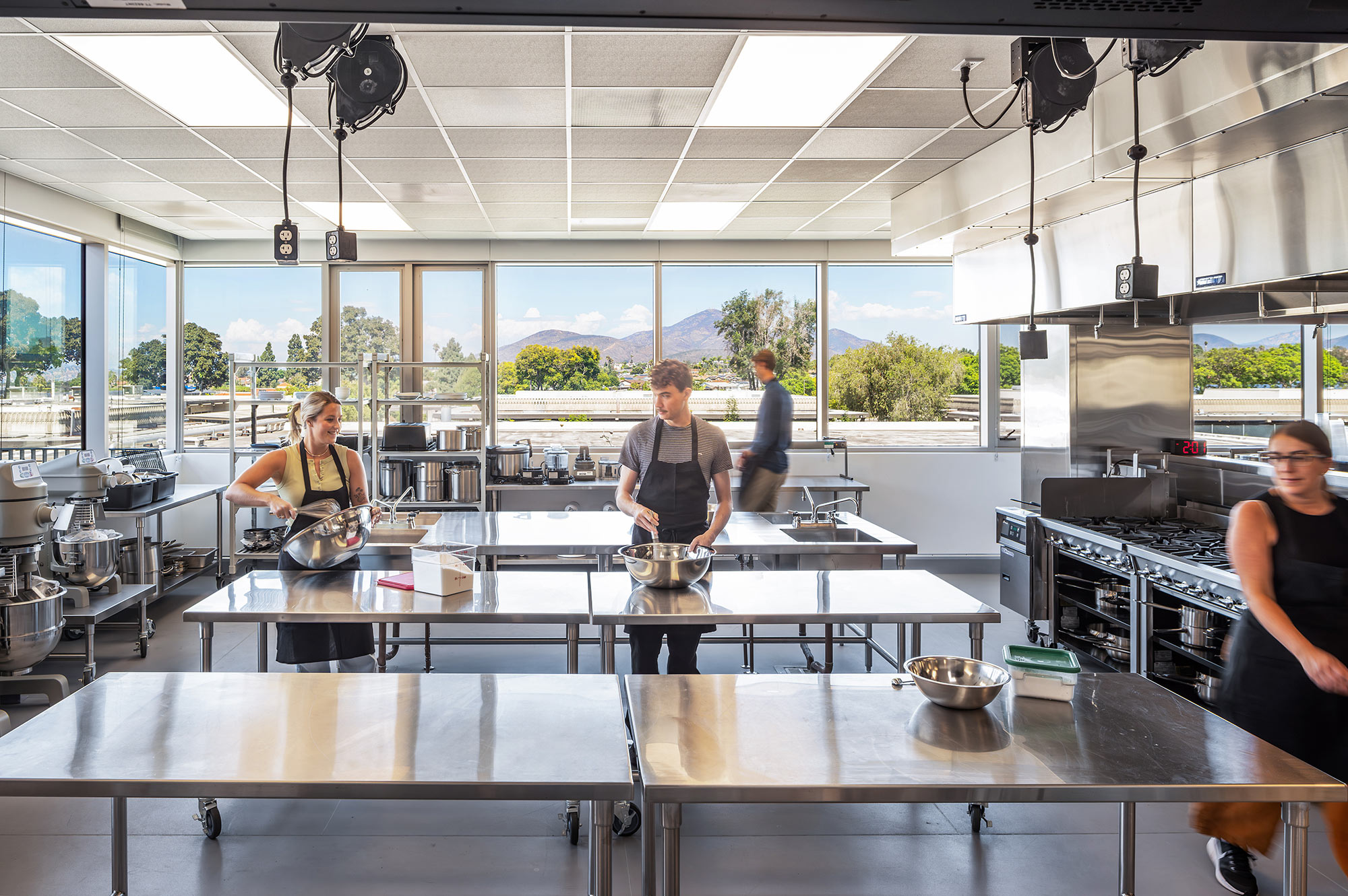 A group of people in a kitchen.