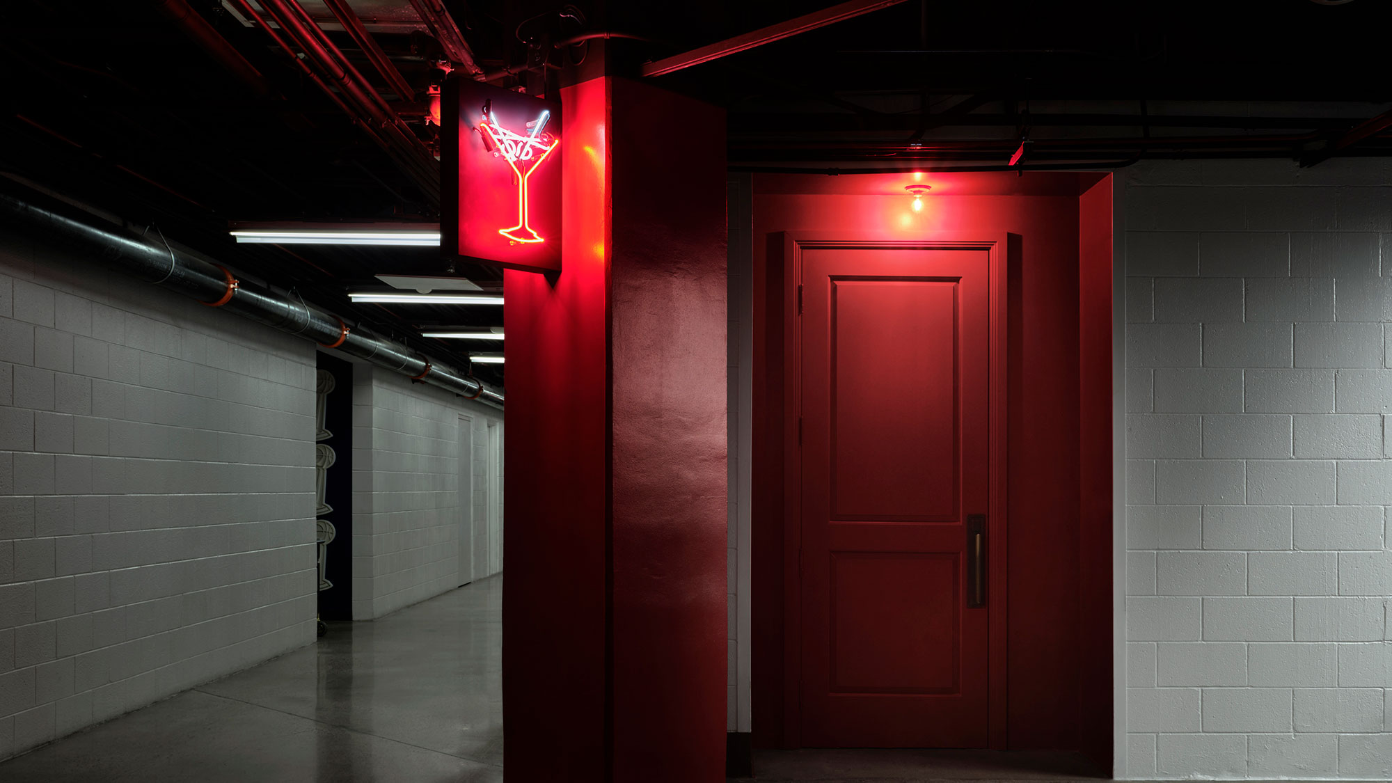 A hallway with red doors.